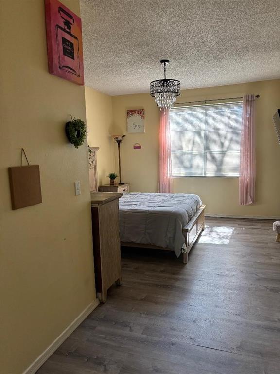 11050 Conch Court Tamarac, FL 33321 - Photo 14 of 17 a bedroom with a bed and wooden floor