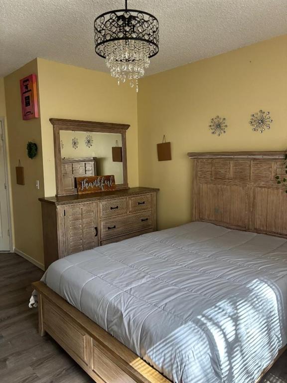 11050 Conch Court Tamarac, FL 33321 - Photo 16 of 17 a bedroom with a bed and a chandelier