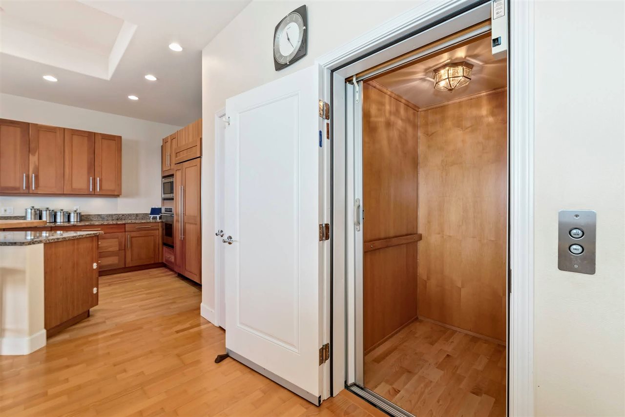 620 Mapuana Place Wailuku, HI 96793 - Photo 12 of 30 a view of a kitchen with wooden floor and a refrigerator