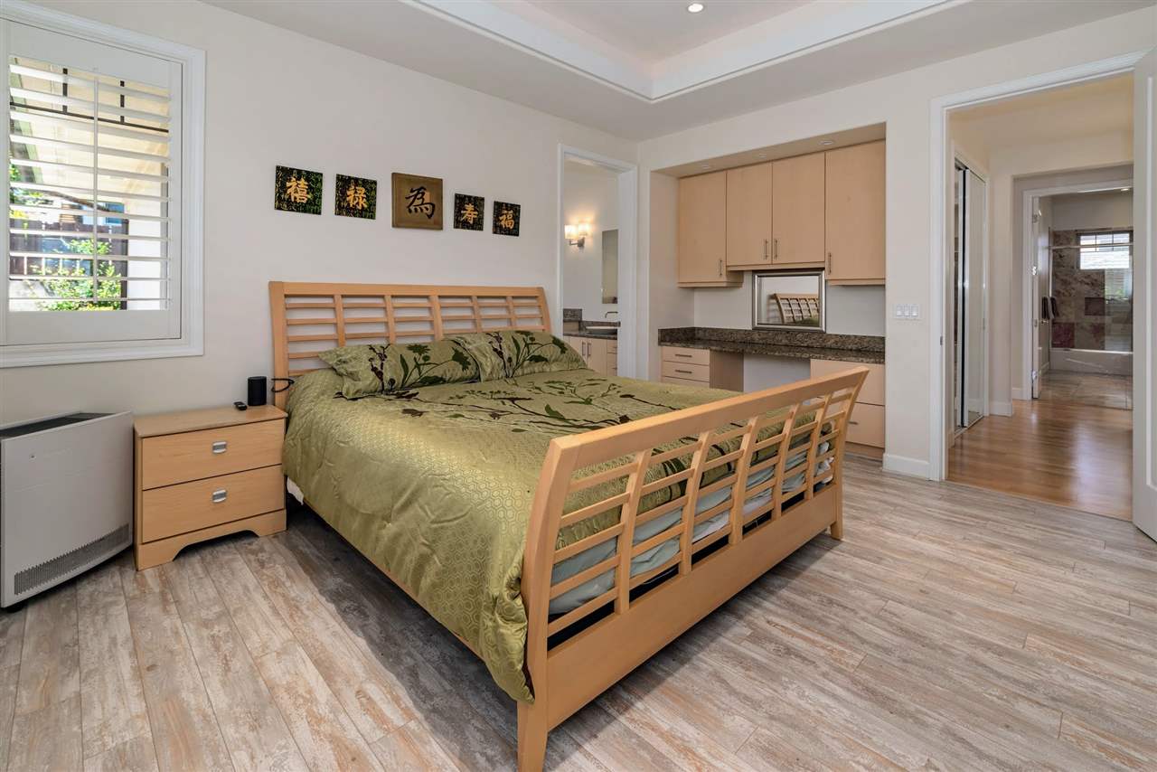 620 Mapuana Place Wailuku, HI 96793 - Photo 14 of 30 a large bedroom with a bed and wooden floor