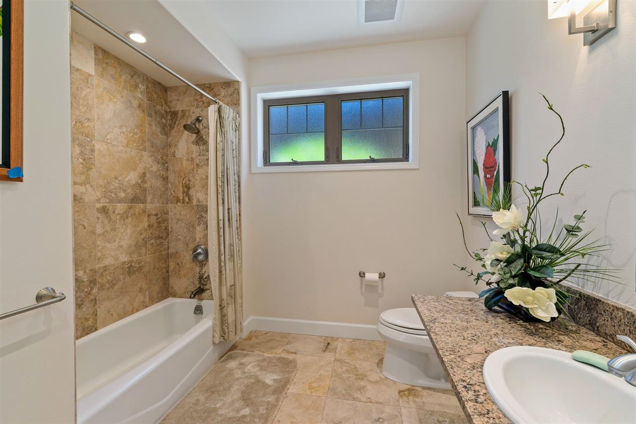 620 Mapuana Place Wailuku, HI 96793 - Photo 28 of 30 a bathroom with a granite countertop sink a toilet and shower