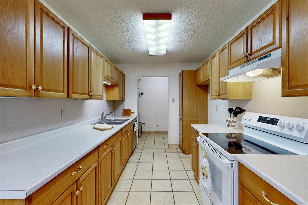 1000 Springdale Road Bedford, TX 76021 - Photo 13 of 36 Everything is within reach in this kitchen, complete with a separate utility room!