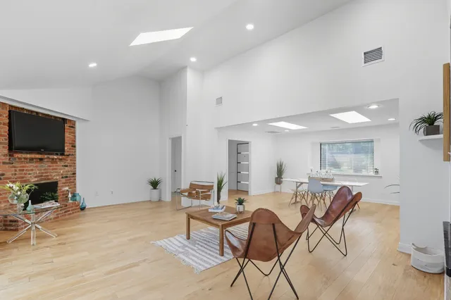a living room with fireplace furniture and a flat screen tv