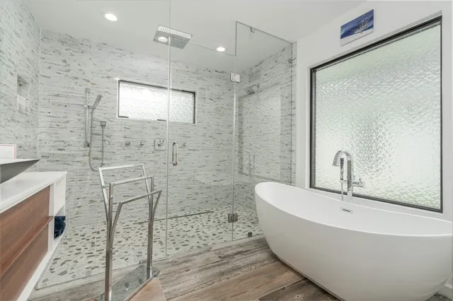 a bathroom with a bathtub and shower