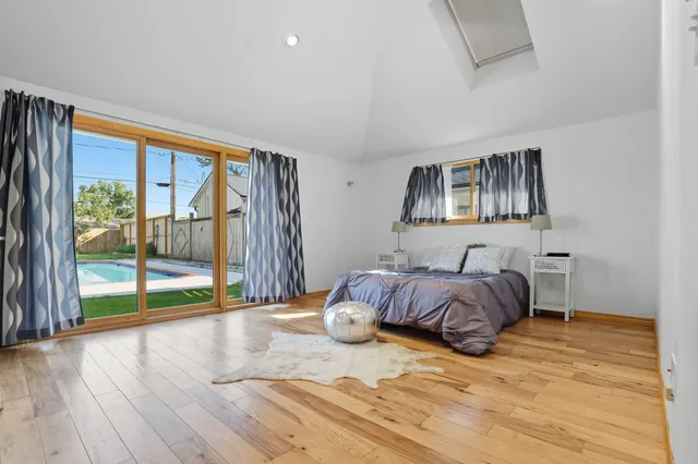 a bedroom with a bed and a large window