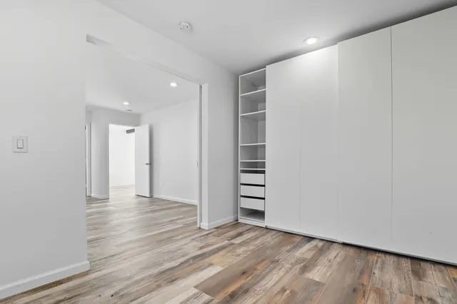 a view of wooden floor and windows in a room