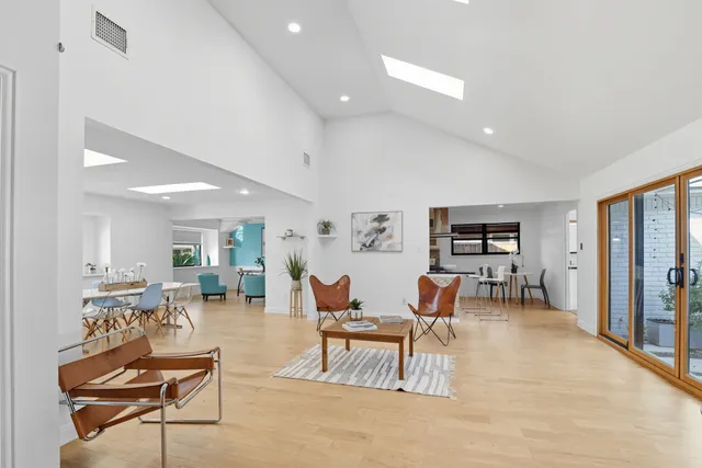 a kitchen with granite countertop white cabinets stainless steel appliances and a counter space