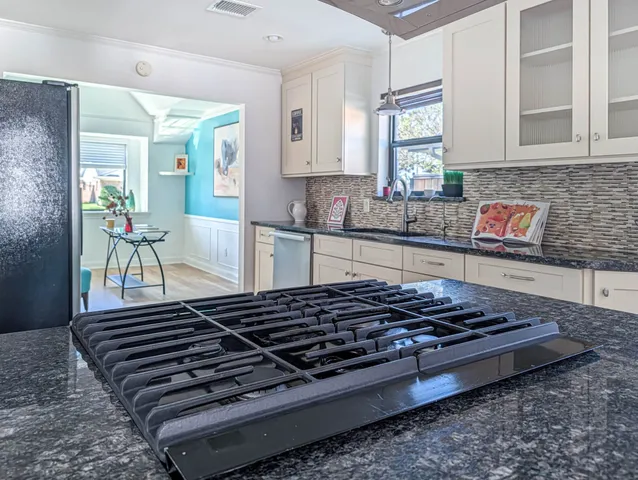 a living room with furniture and a dining room