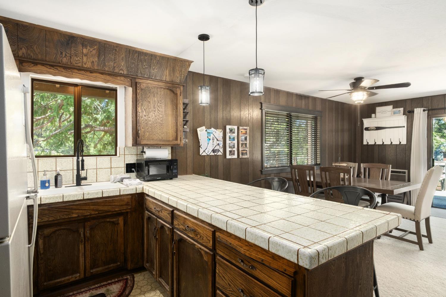 42488 Rock Ledge Road Shaver Lake, CA 93664 - Photo 16 of 26 a kitchen with a sink a stove and a chandelier