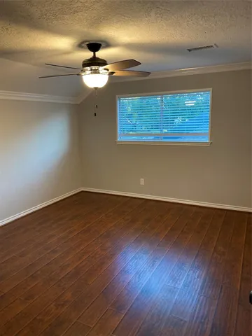 a view of a room with wooden floor