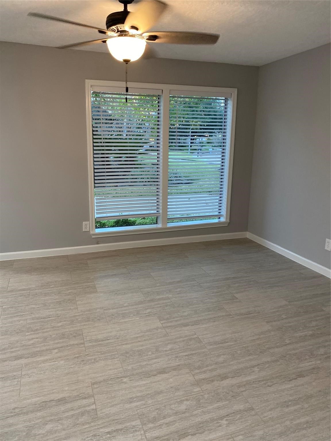 1622 Fall Valley Drive Houston, TX 77077 - Photo 9 of 10 a view of an empty room with wooden floor and a window