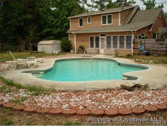 6024 Smithfield Road Wade, NC 28395 - Photo 4 of 25 a front view of a house with swimming pool