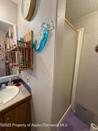 a bathroom with a sink a mirror and vanity