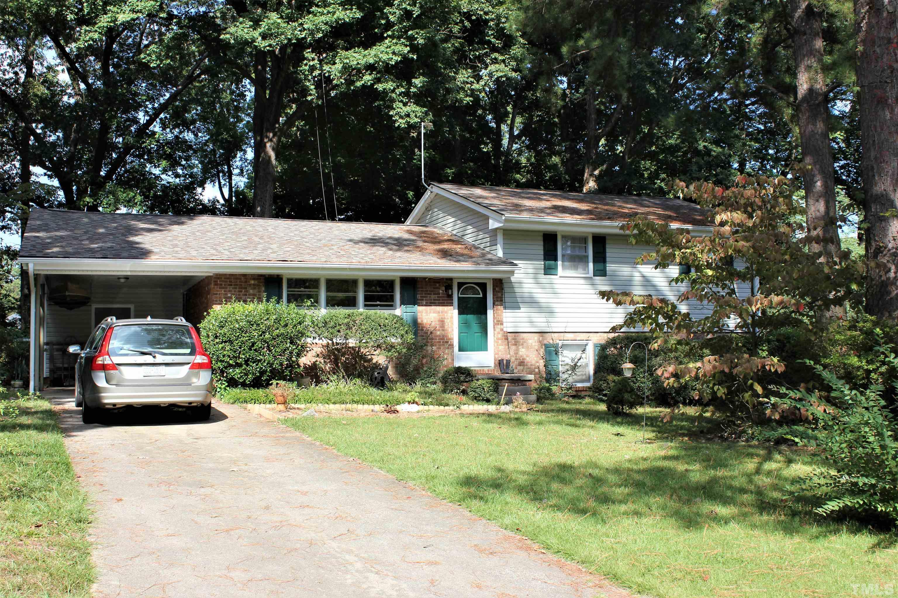 3205 Fairforest Place Raleigh, NC 27604 - Photo 1 of 28 a front view of a house with a yard and garage