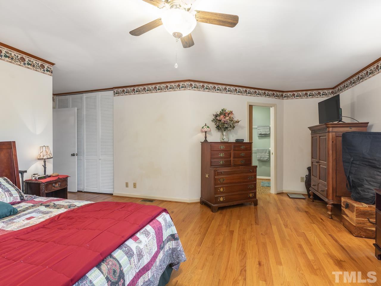 3205 Fairforest Place Raleigh, NC 27604 - Photo 18 of 28 a bedroom with a bed and wooden floor