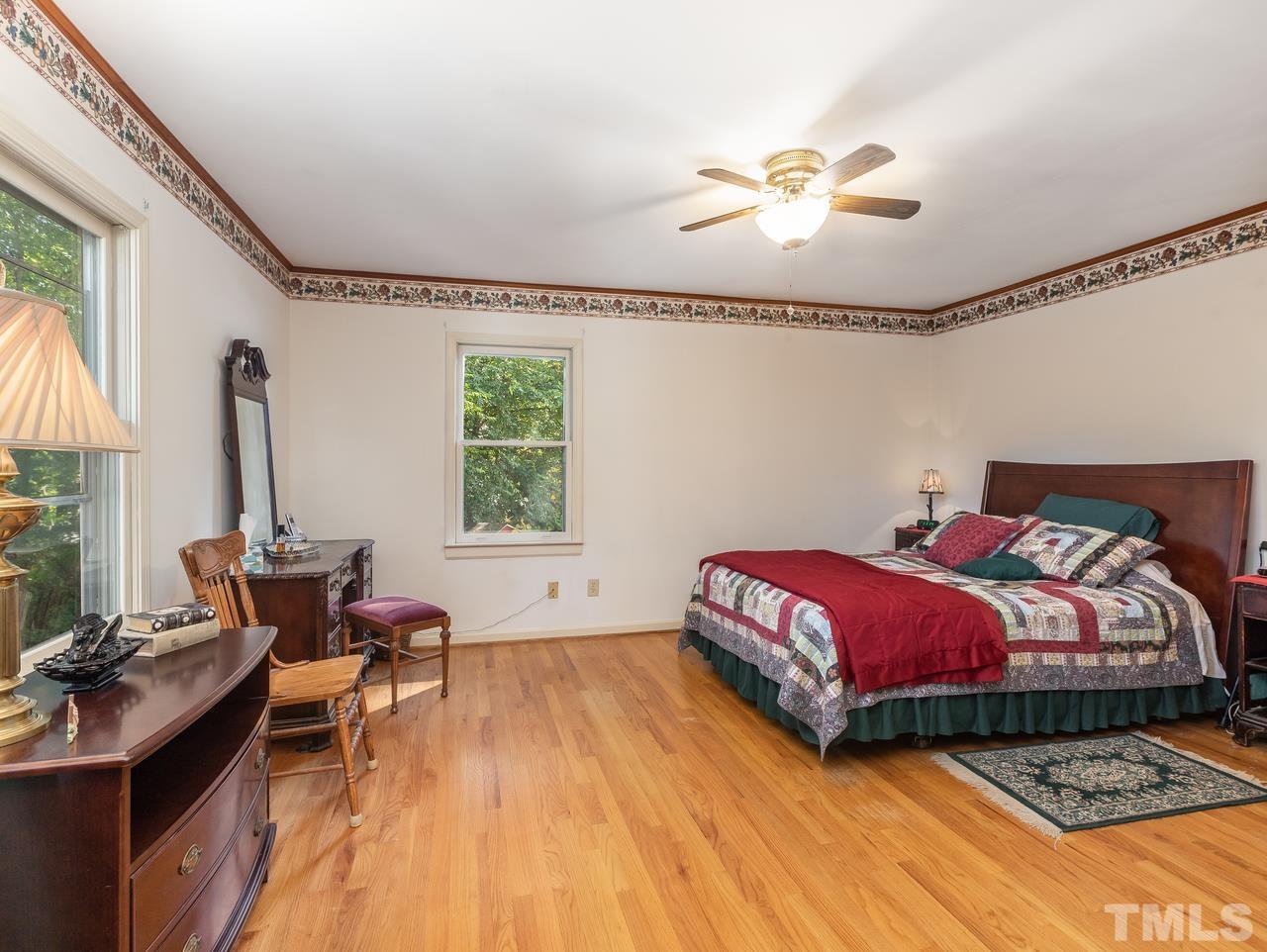 3205 Fairforest Place Raleigh, NC 27604 - Photo 19 of 28 a bedroom with a bed and a chandelier