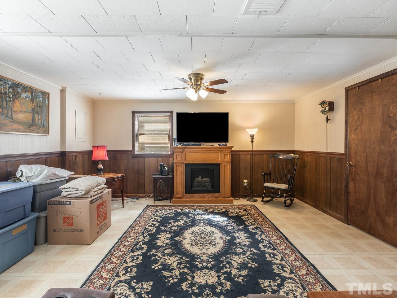 3205 Fairforest Place Raleigh, NC 27604 - Photo 25 of 28 a living room with a flat screen tv and a fireplace