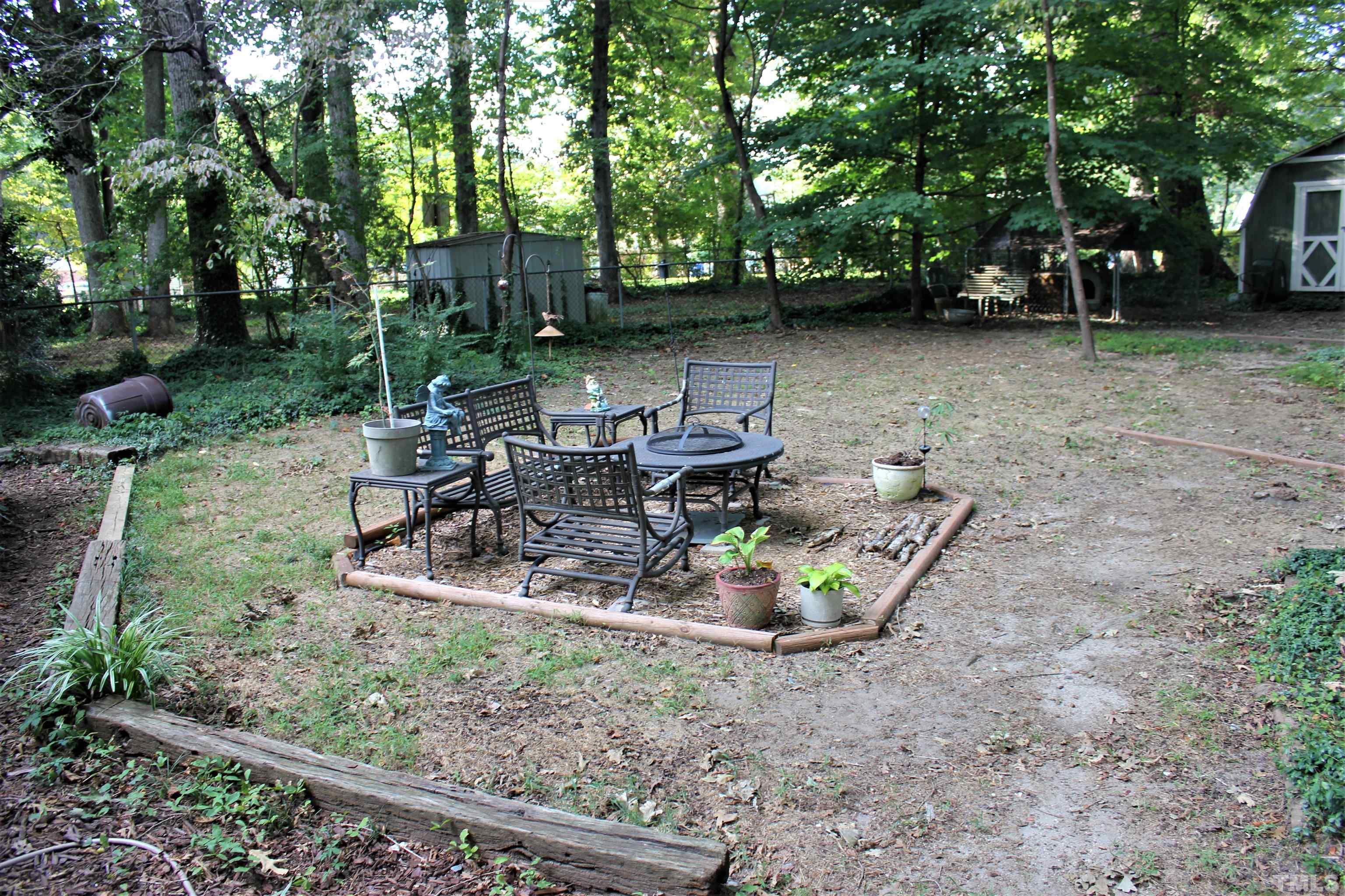 3205 Fairforest Place Raleigh, NC 27604 - Photo 4 of 28 a backyard of a house with table and chairs
