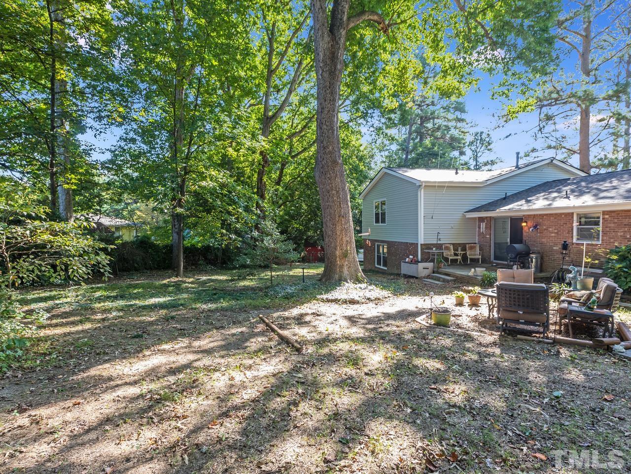 3205 Fairforest Place Raleigh, NC 27604 - Photo 8 of 28 a backyard of a house with yard and outdoor seating