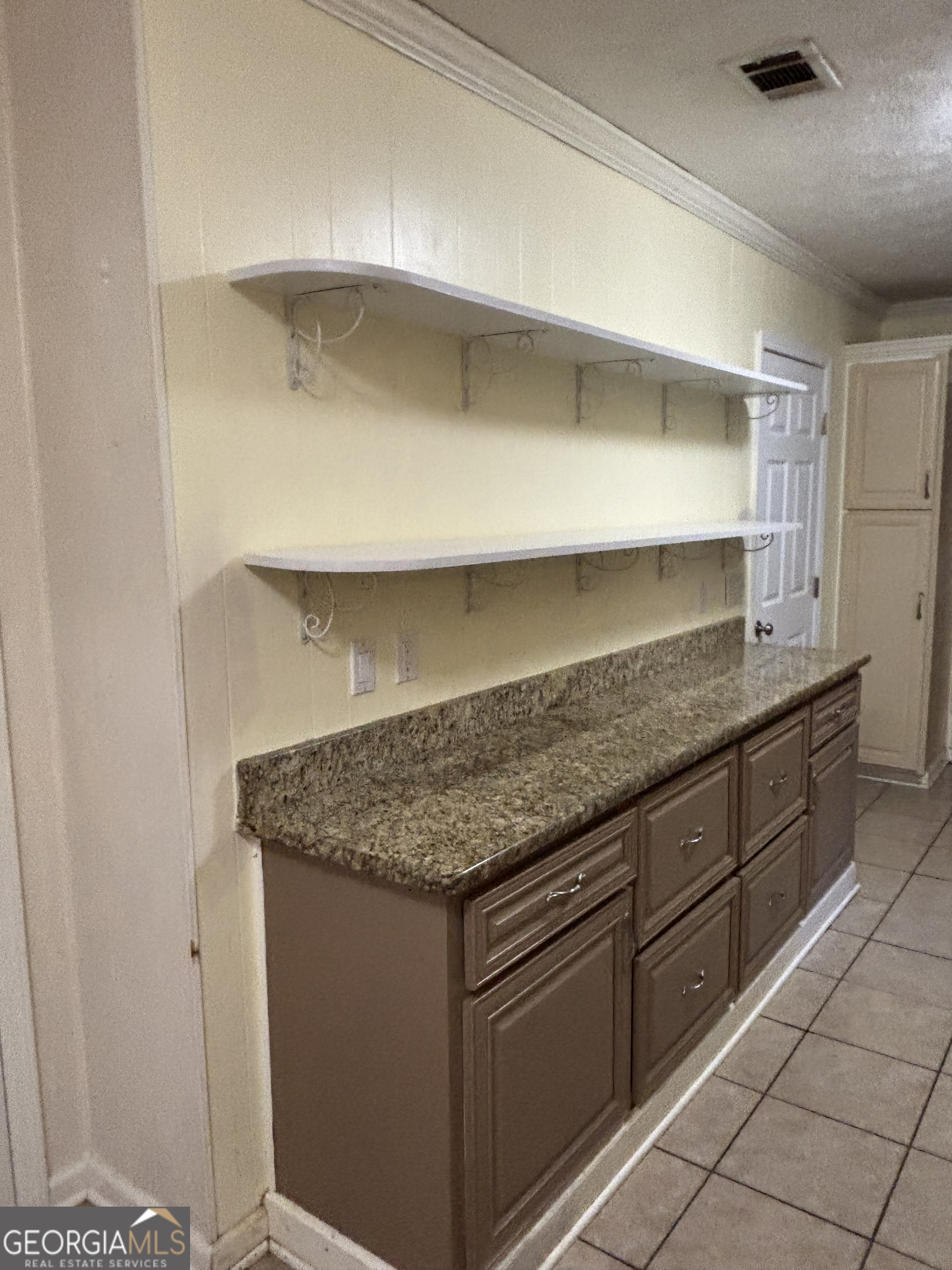 228 Sivell Road LaGrange, GA 30241 - Photo 16 of 64 a kitchen with granite countertop a sink and a wooden cabinets