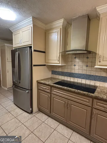 a kitchen with stainless steel appliances granite countertop a refrigerator and a stove