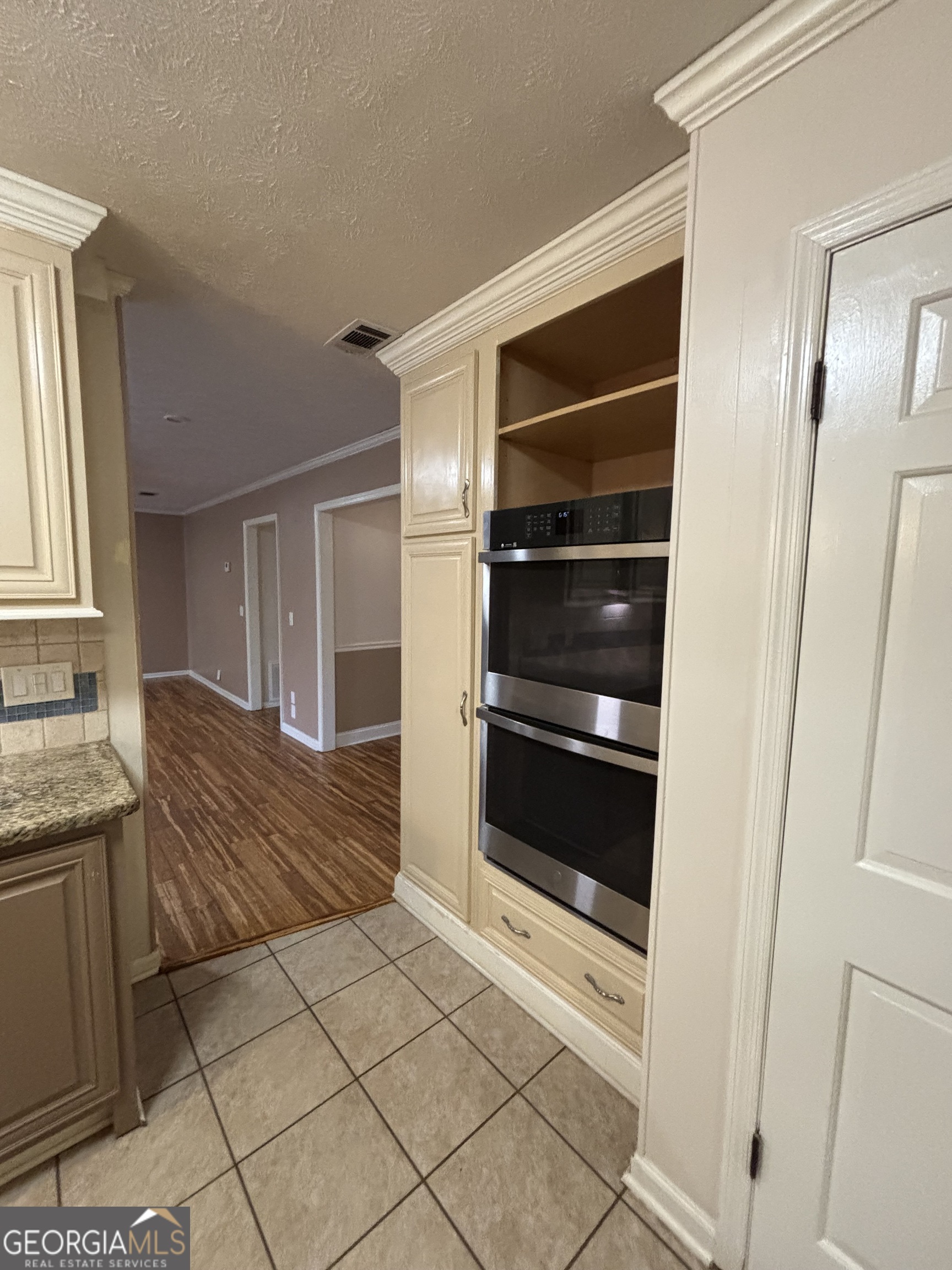 228 Sivell Road LaGrange, GA 30241 - Photo 23 of 64 a kitchen with a refrigerator and a stove top oven