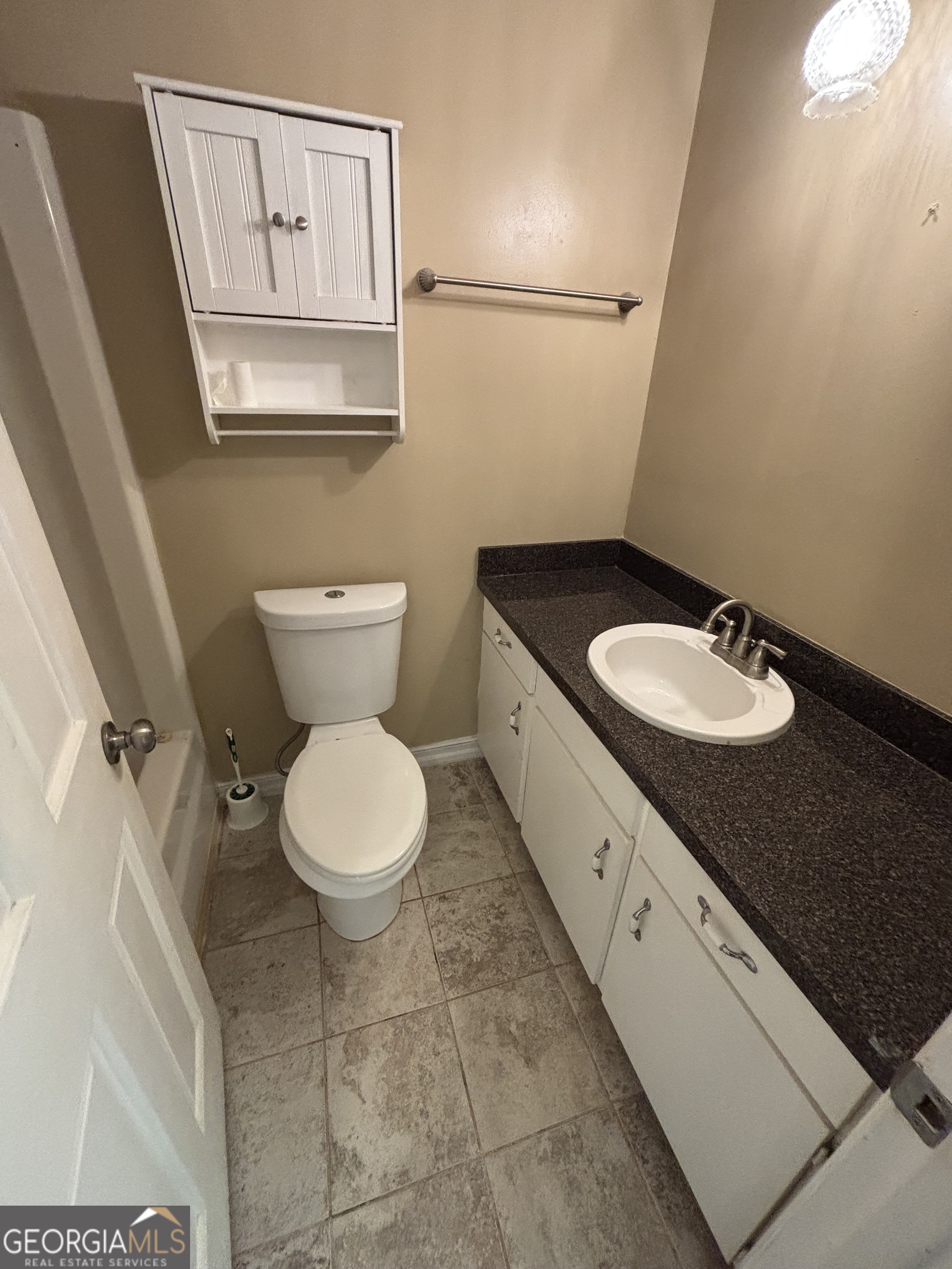 228 Sivell Road LaGrange, GA 30241 - Photo 29 of 64 a bathroom with a granite countertop toilet sink and mirror