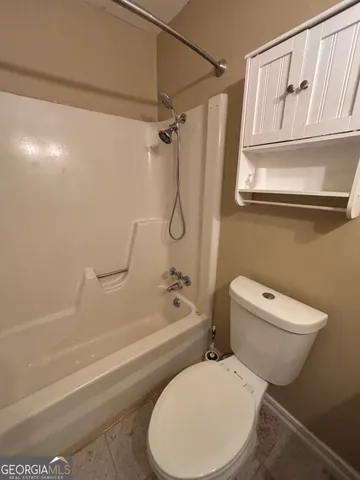 a view of empty room with wooden floor and fireplace