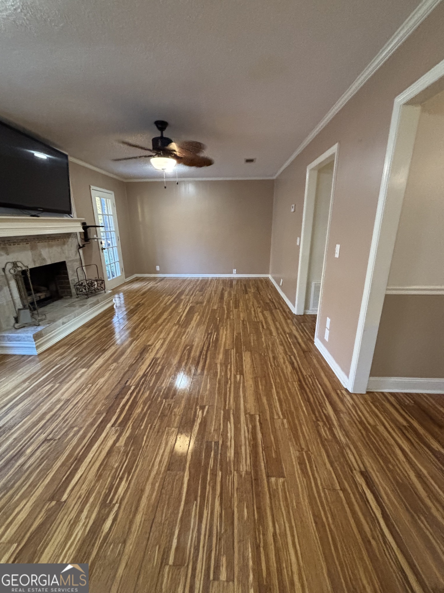 228 Sivell Road LaGrange, GA 30241 - Photo 39 of 64 wooden floor in an empty room with a fireplace