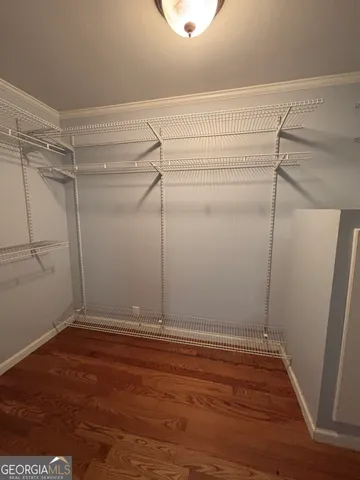 a view of a room with wooden floor