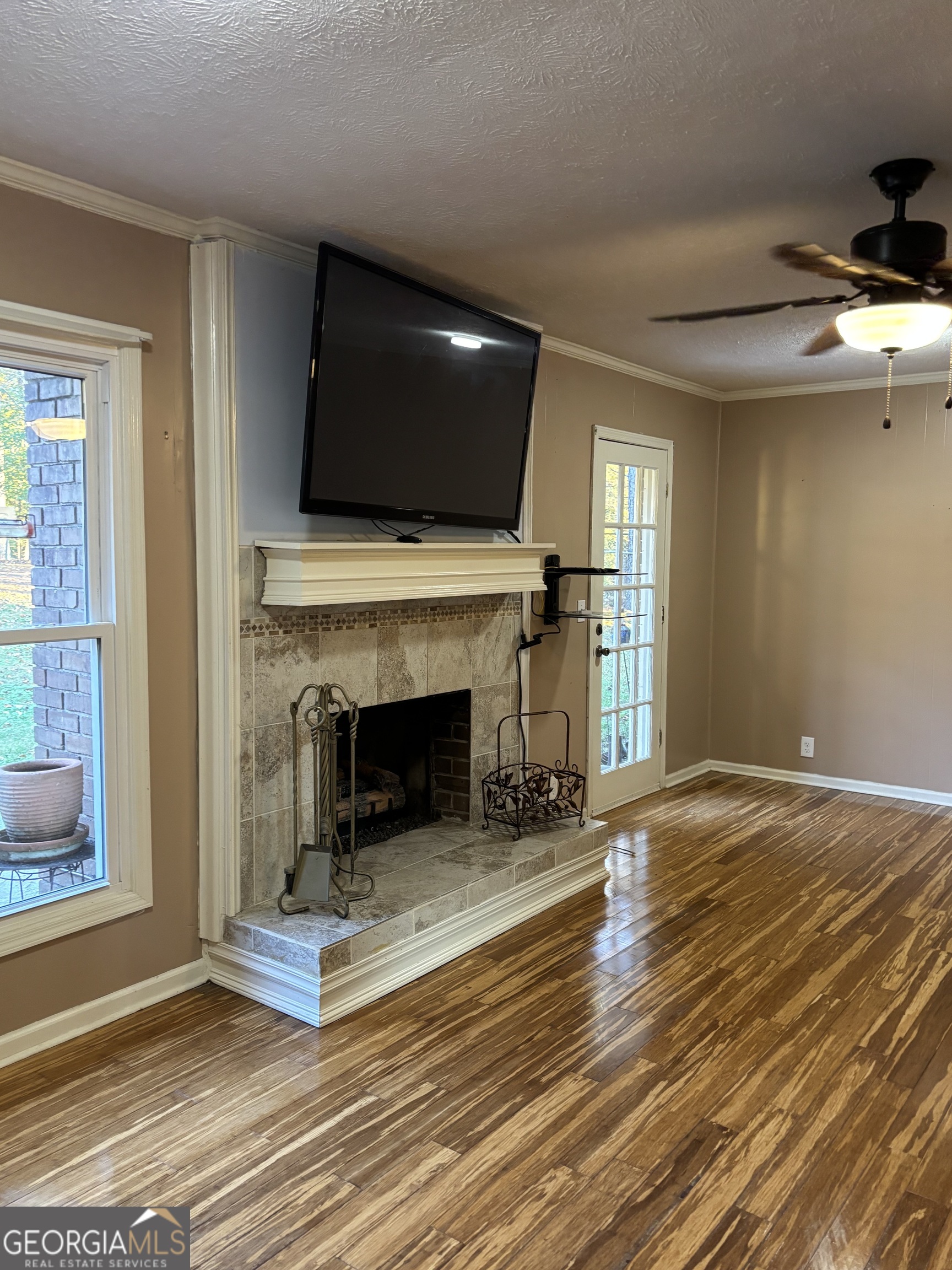 228 Sivell Road LaGrange, GA 30241 - Photo 43 of 64 a living room with a fireplace and a flat screen tv