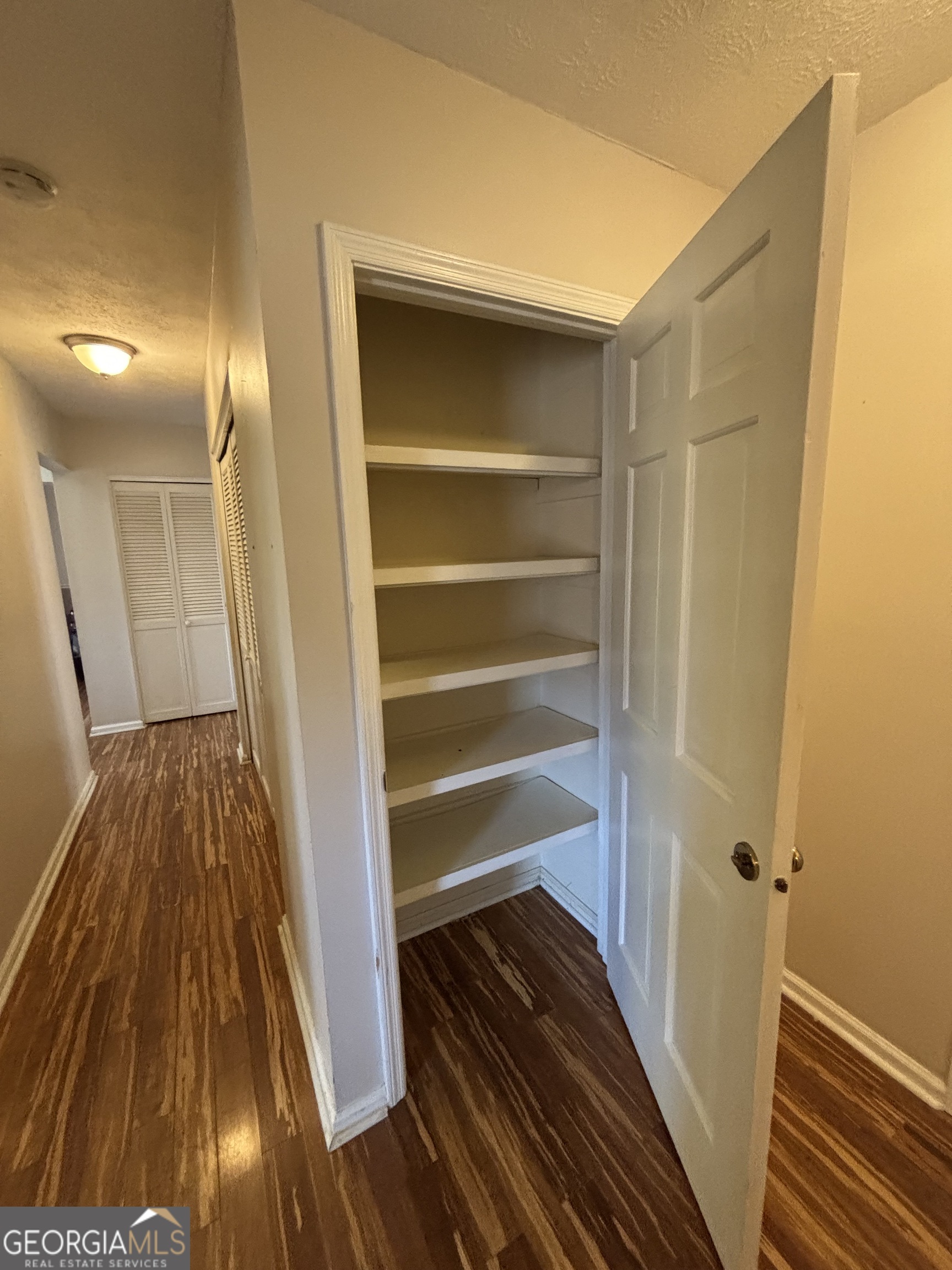 228 Sivell Road LaGrange, GA 30241 - Photo 7 of 64 a view of walk in closet with wooden floor