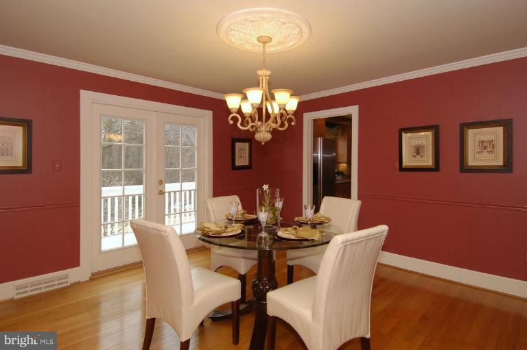 2827 Rifle Ridge Road Oakton, VA 22124 - Photo 12 of 27 a dining room with furniture and chandelier