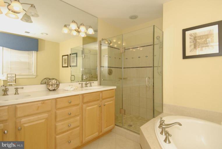 2827 Rifle Ridge Road Oakton, VA 22124 - Photo 16 of 27 a bathroom with a granite countertop sink mirror and double