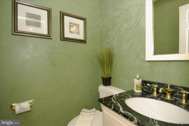 2827 Rifle Ridge Road Oakton, VA 22124 - Photo 21 of 27 a bathroom with a granite countertop sink and a mirror