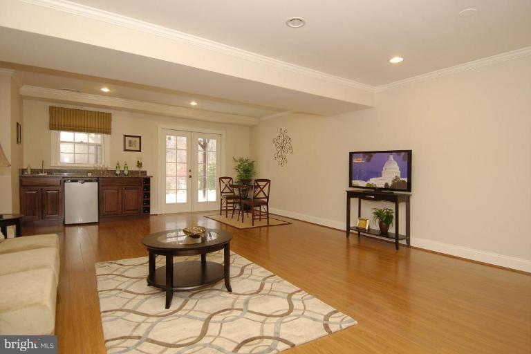 2827 Rifle Ridge Road Oakton, VA 22124 - Photo 4 of 27 a living room with furniture a dining table and kitchen view with wooden floor