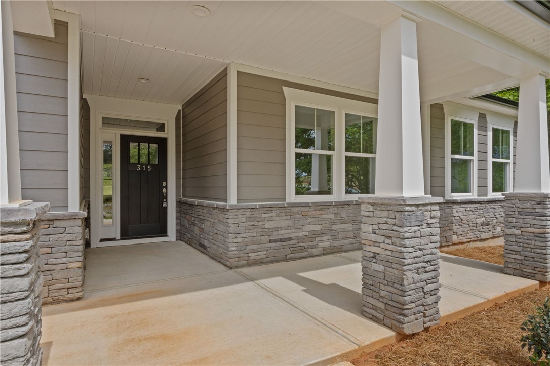 315 Old Shirley Road Central, SC 29630 - Photo 3 of 26 This home features a welcoming front porch with charming stone accents and inviting curb appeal.