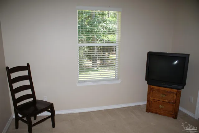 a view of workspace with a window and furniture