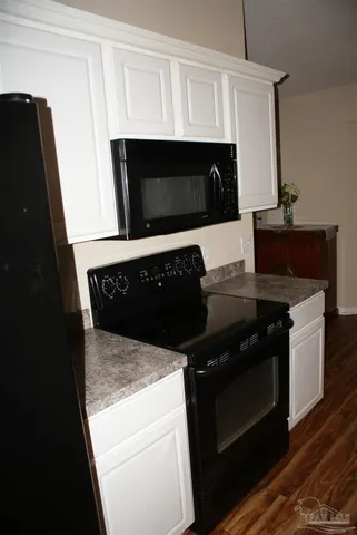 a kitchen with a stove and a microwave