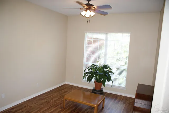 a view of a room with wooden floor and windows