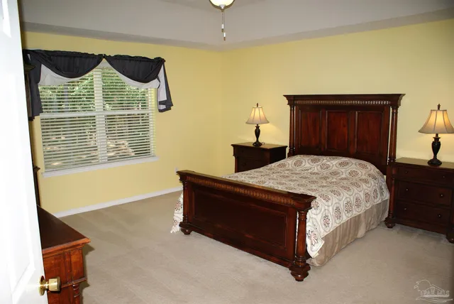 a spacious bedroom with a bed and a window