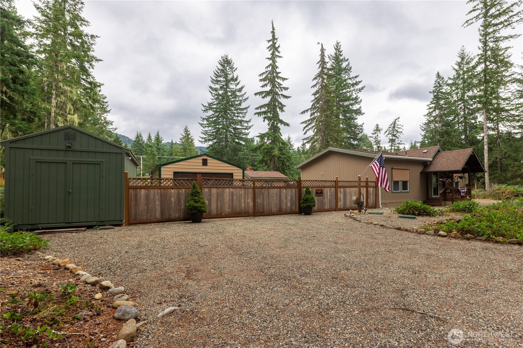 20 Northeast Mallard Way Hoodsport, WA 98548 - Photo 2 of 23 a front view of a house with a yard and garage