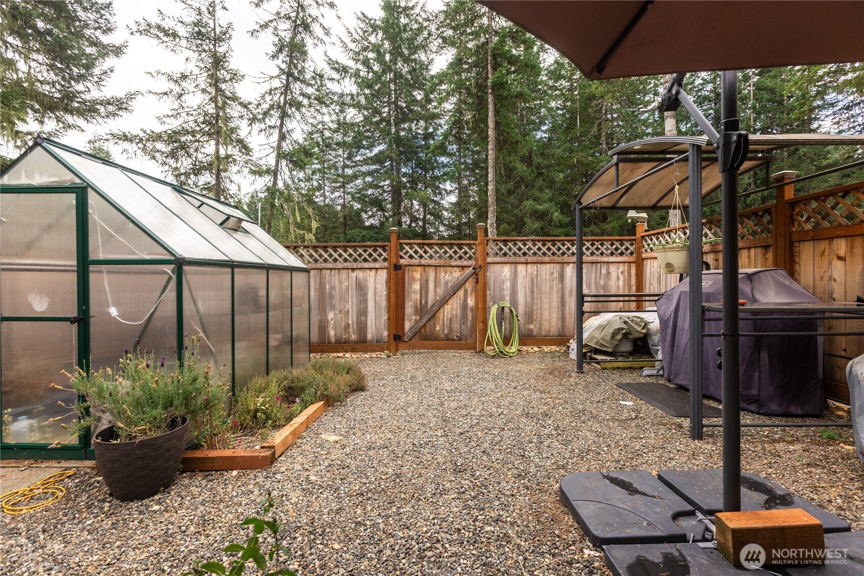 20 Northeast Mallard Way Hoodsport, WA 98548 - Photo 22 of 23 a backyard of a house with wooden floor barbeque oven and outdoor seating