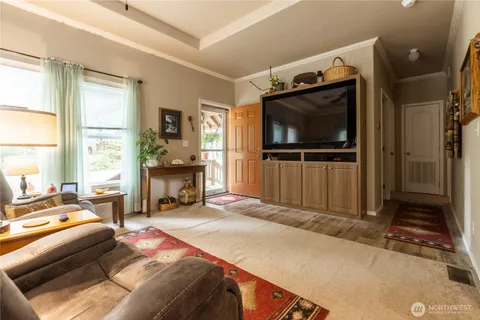 a bedroom with furniture and a flat screen tv