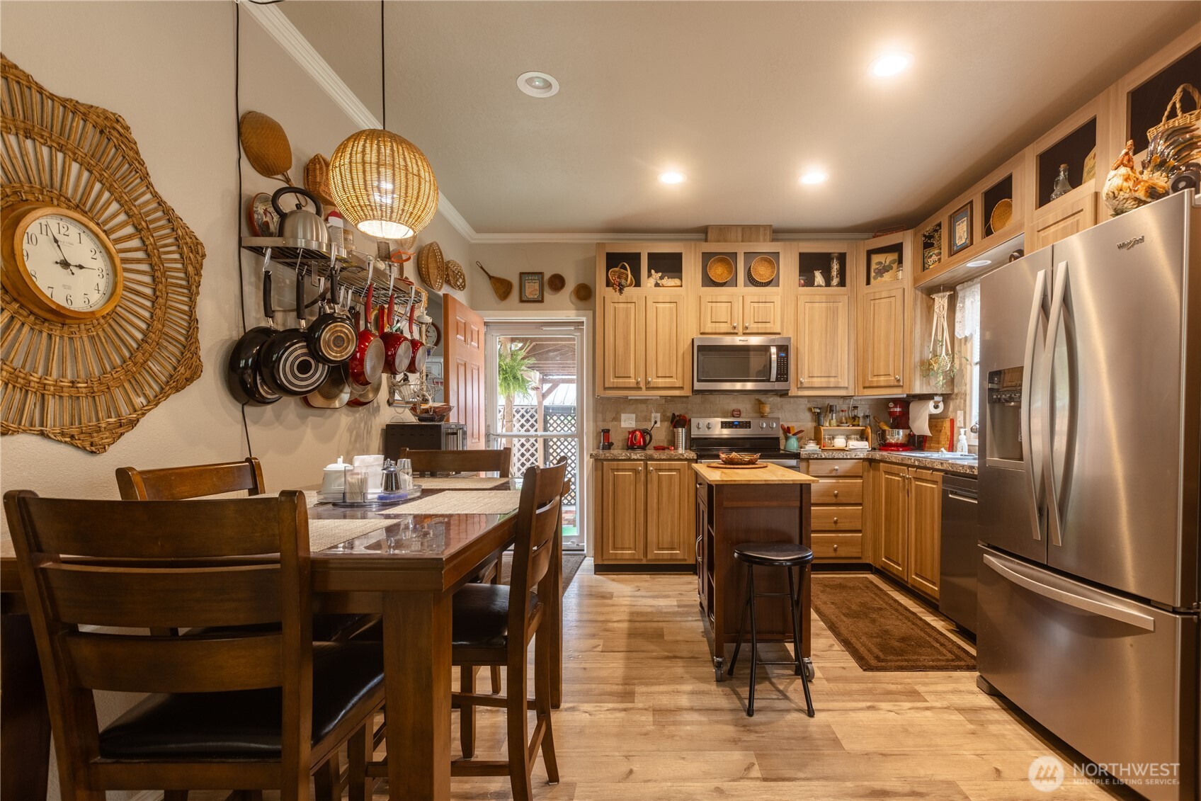 20 Northeast Mallard Way Hoodsport, WA 98548 - Photo 8 of 23 a kitchen with stainless steel appliances kitchen island granite countertop a refrigerator a stove a oven with white cabinets and wooden floor