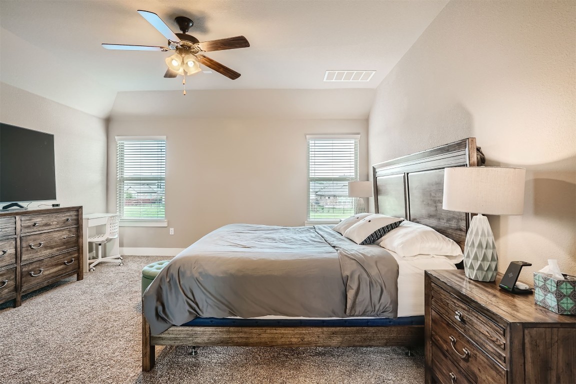 9401 McKnight Loop, Unit 6 Austin, TX 78717 - Photo 13 of 28 a bedroom with a bed and a flat screen tv