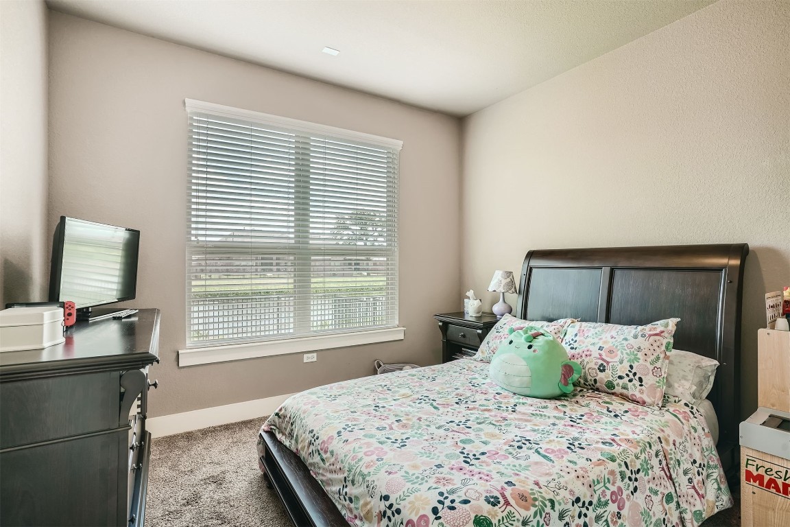 9401 McKnight Loop, Unit 6 Austin, TX 78717 - Photo 18 of 28 a bedroom with a large bed and a window