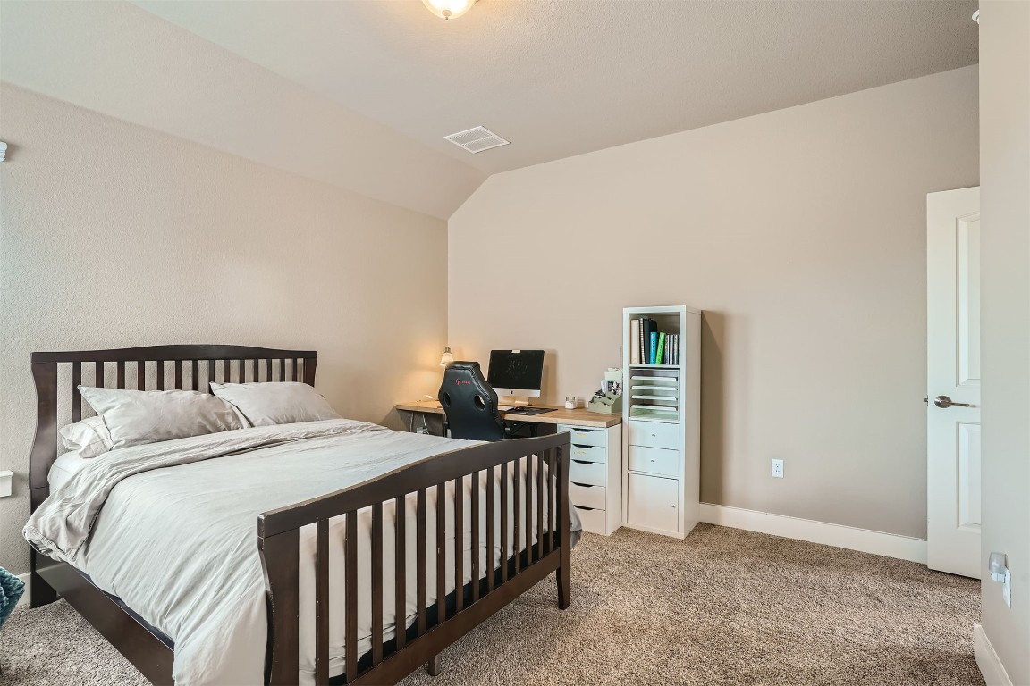 9401 McKnight Loop, Unit 6 Austin, TX 78717 - Photo 23 of 28 a bedroom with a bed and a window