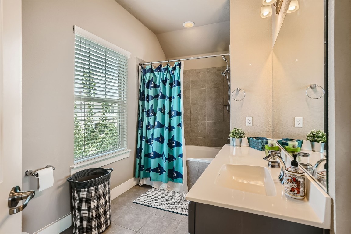 9401 McKnight Loop, Unit 6 Austin, TX 78717 - Photo 24 of 28 a bathroom with a sink and a mirror