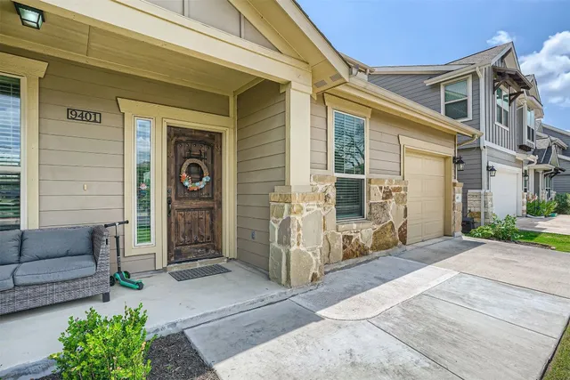 a view of a swimming pool with a couches chairs and a yard